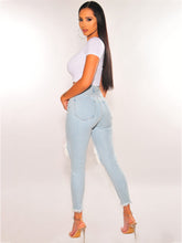 Vaqueros desgastados, ajustados, de cintura media y elásticos